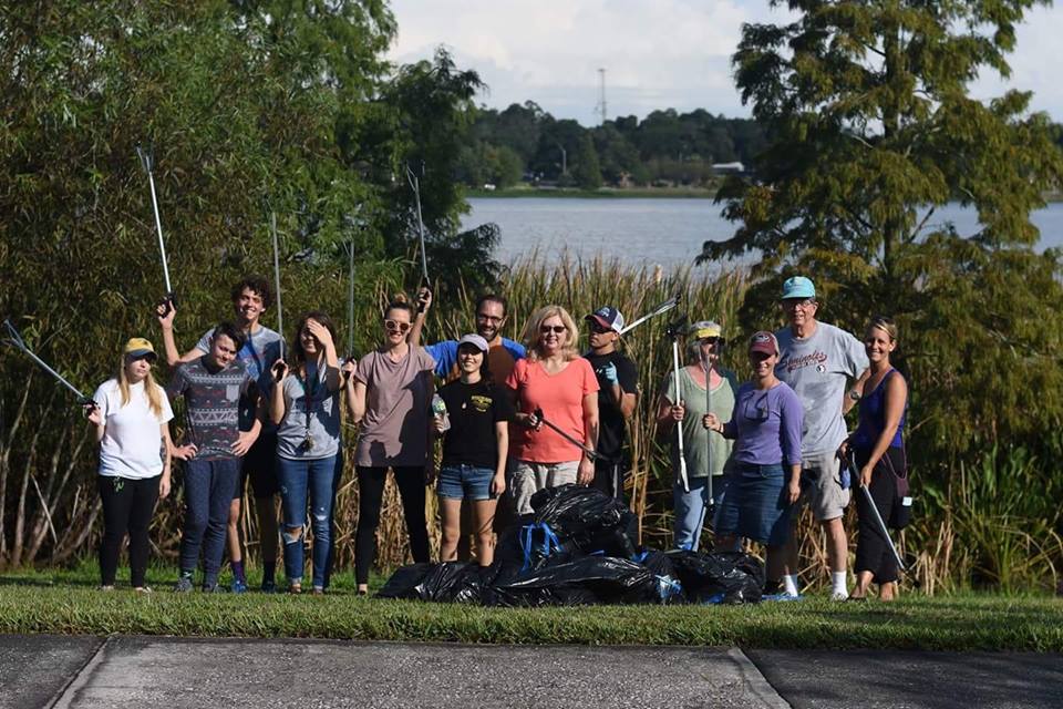 Group of volunteers pose with trash they picked up at Lake Hunter